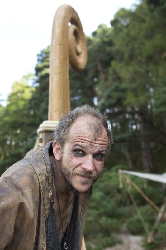 man with staff in forest