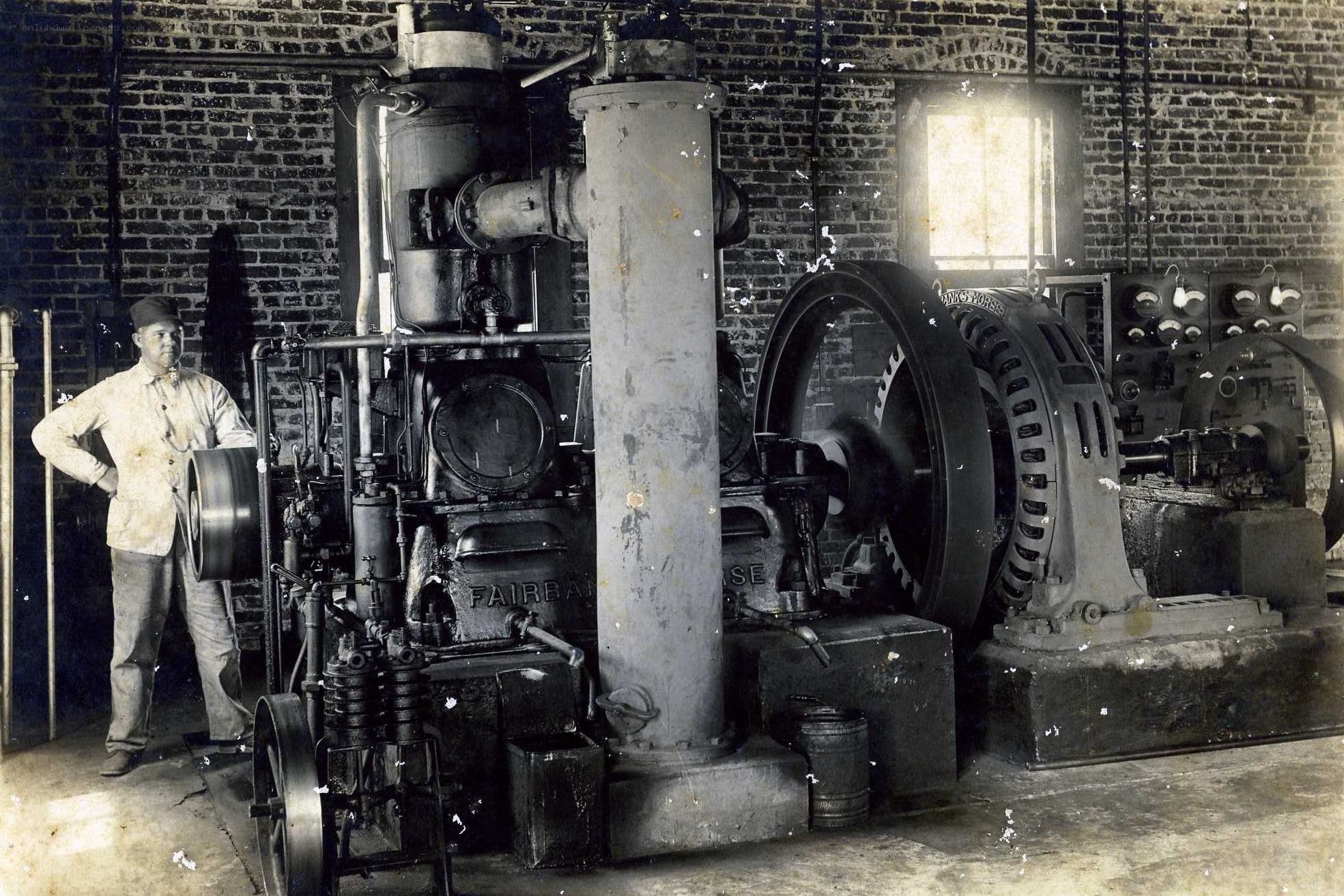 Man with steam engine in factory