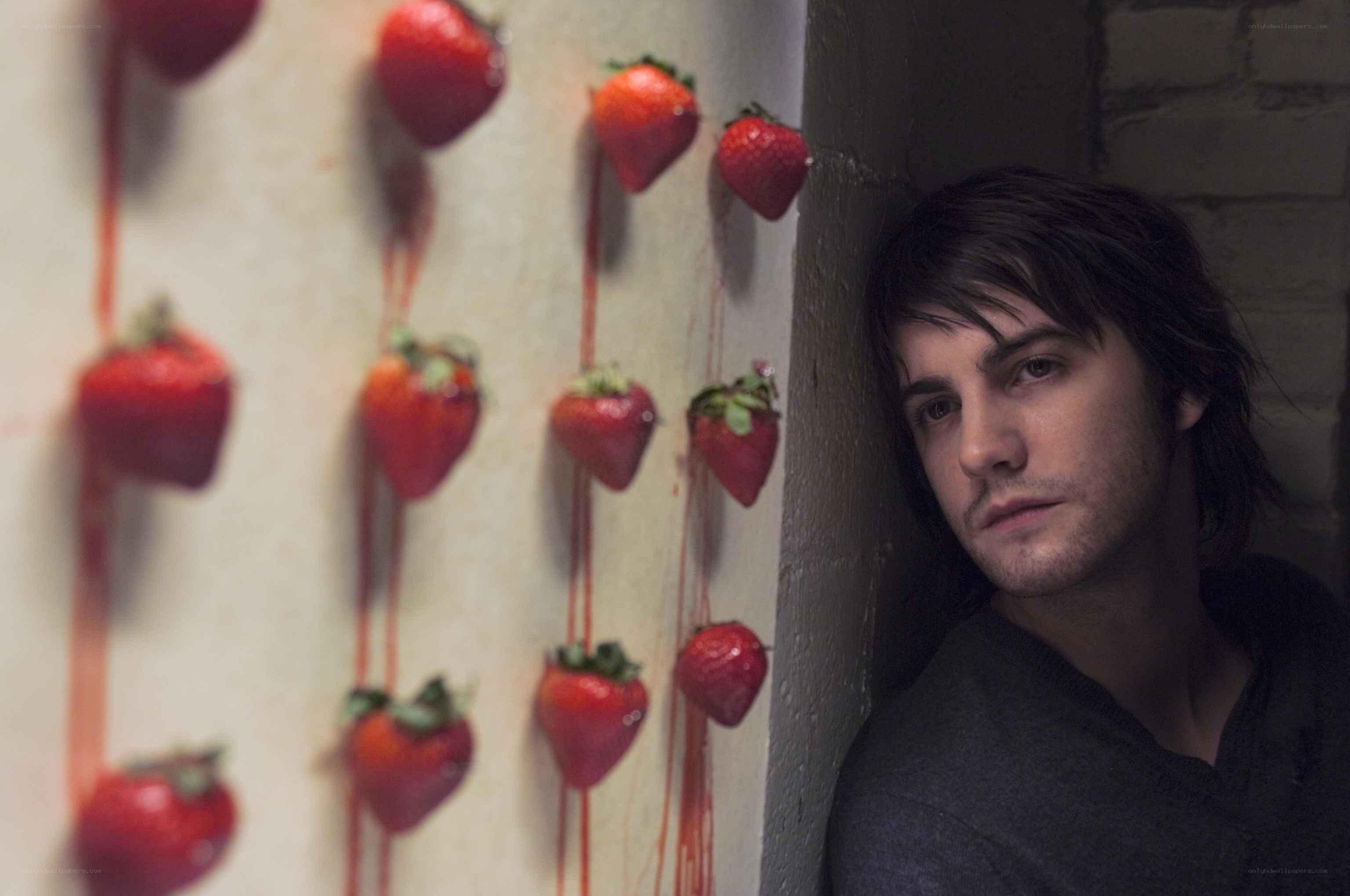man with strawberries on wall