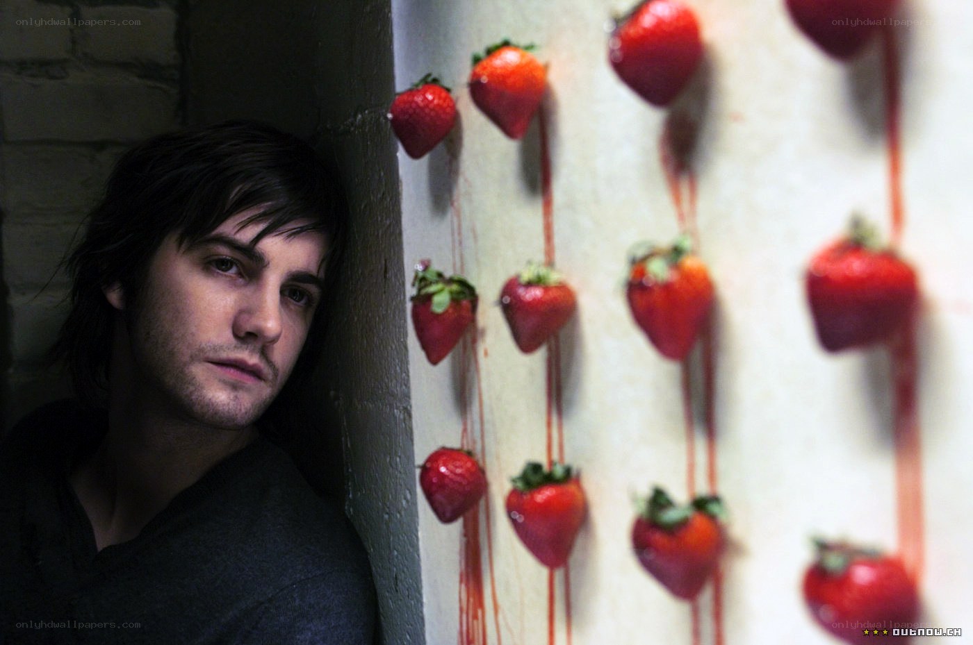 man with strawberries on wall