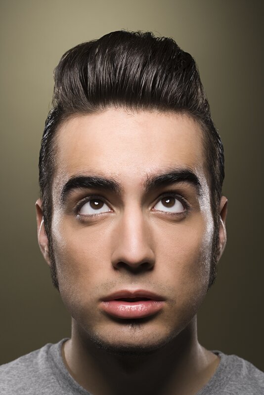 man with styled hair looking up