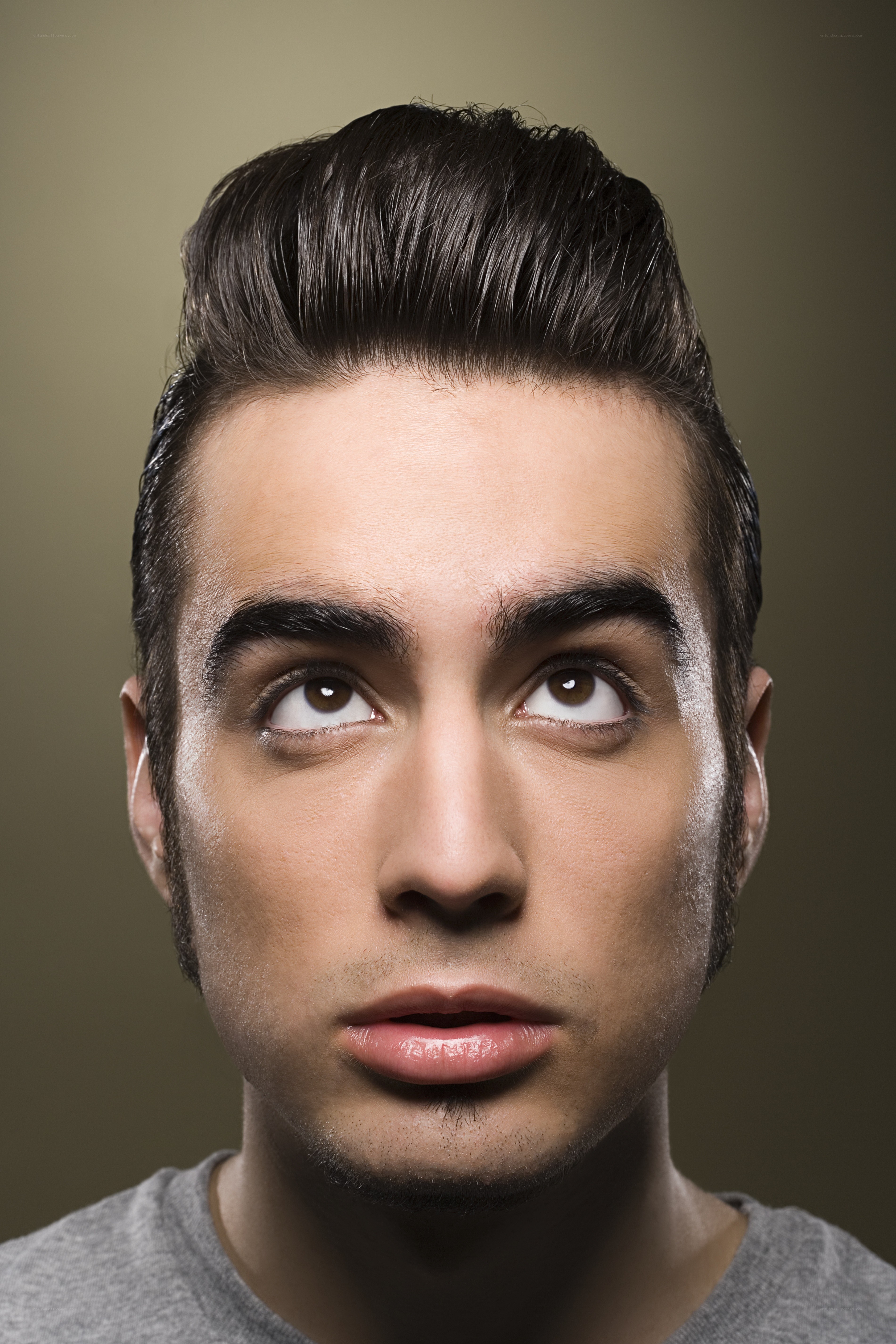 man with styled hair looking up