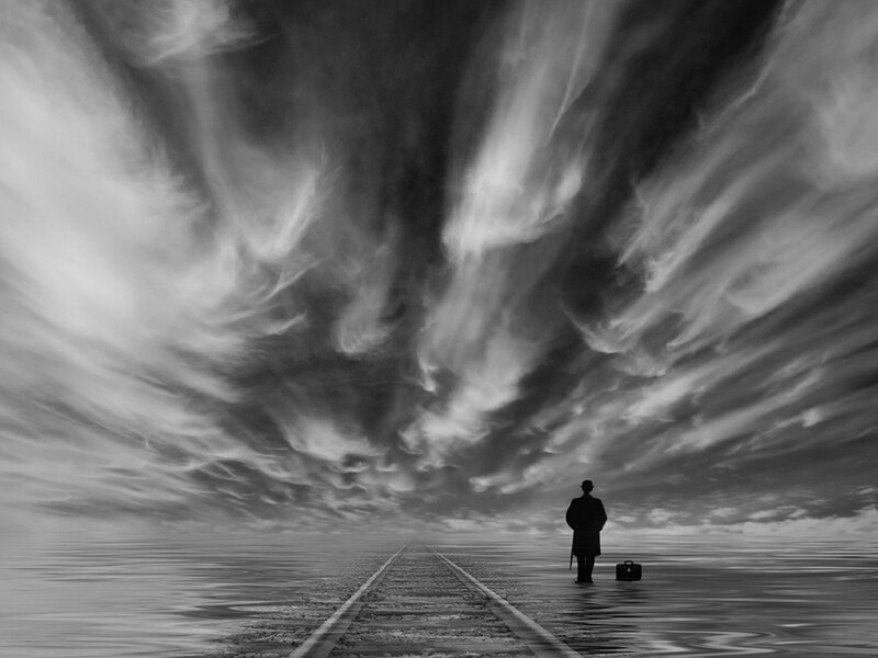 Man with Suitcase on Tracks