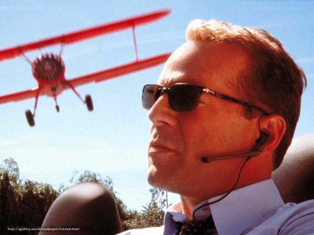man with sunglasses and biplane