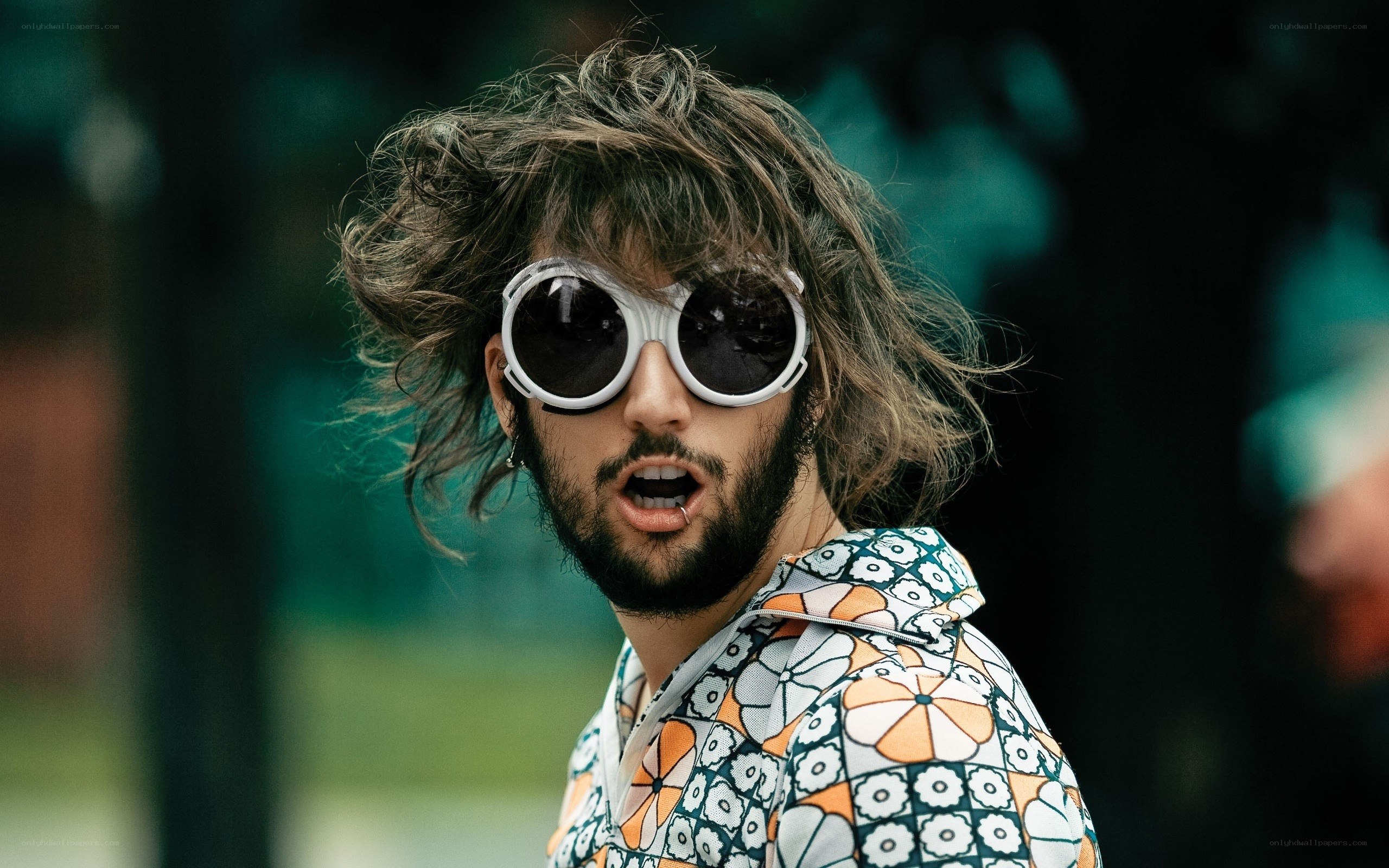 man with sunglasses and patterned shirt