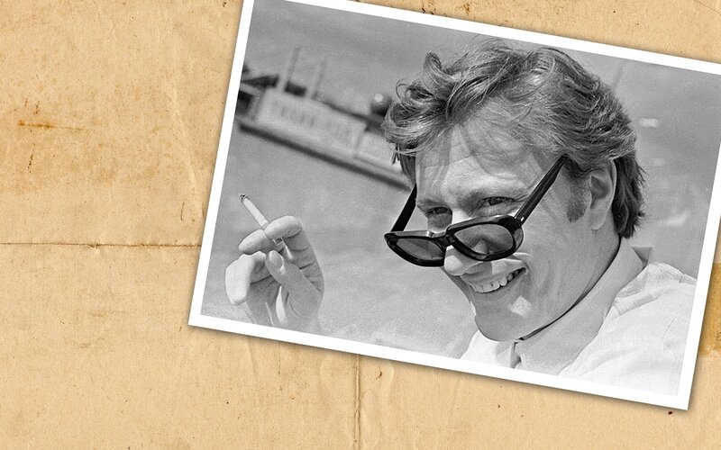 Man with sunglasses holding cigarette