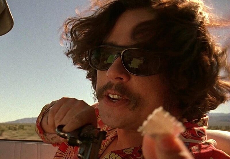 man with sunglasses holding gun