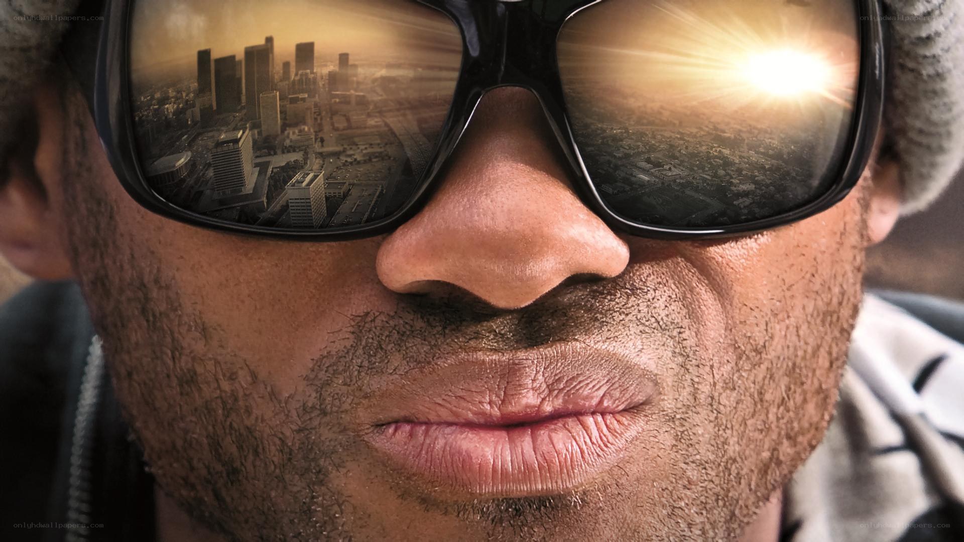 man with sunglasses reflecting city