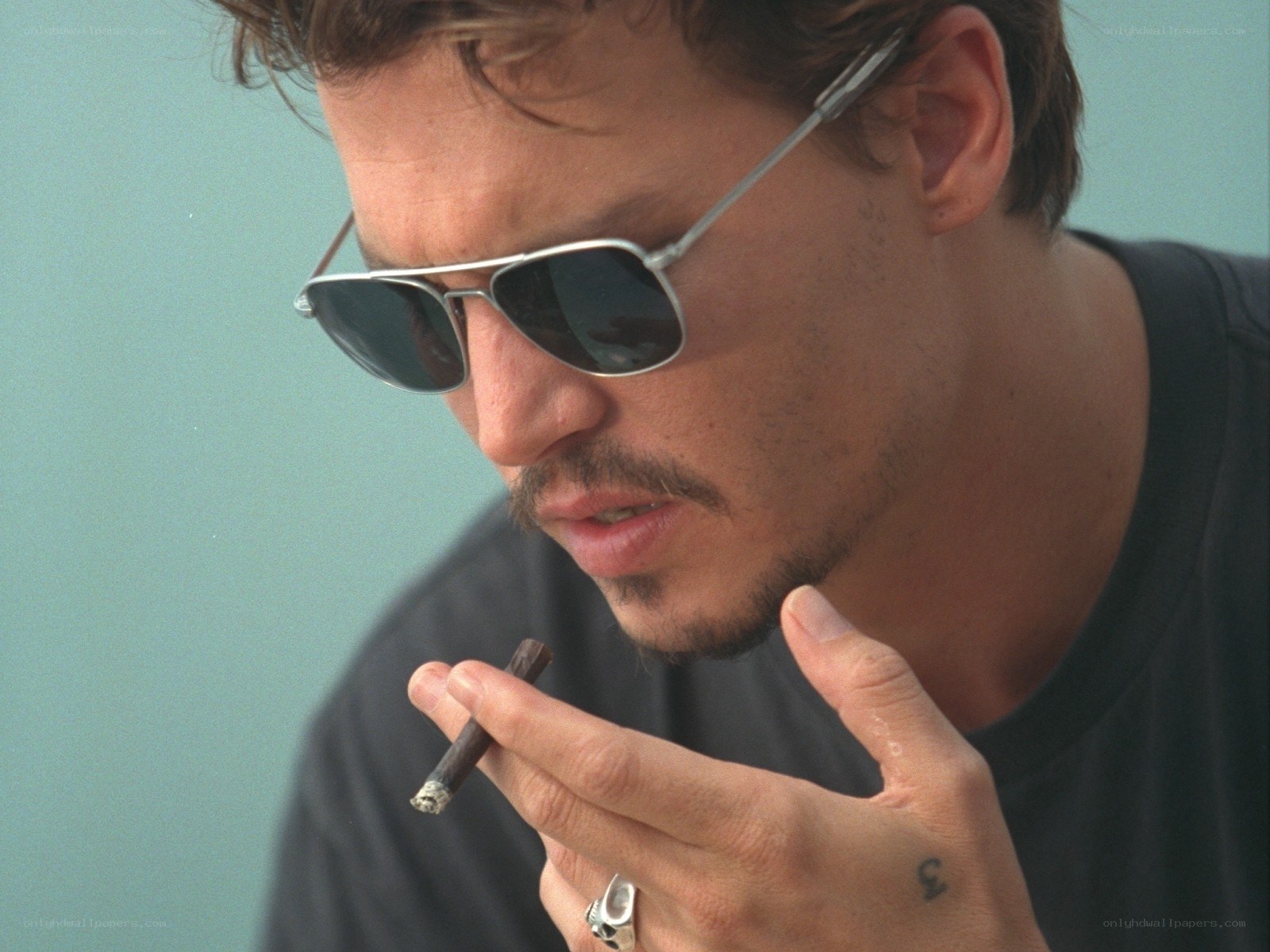 man with sunglasses smoking cigar