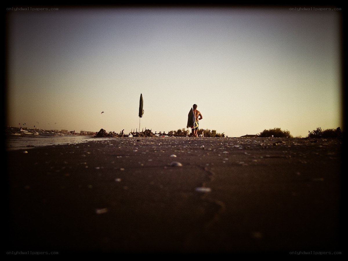 Man with surfboard on beach
