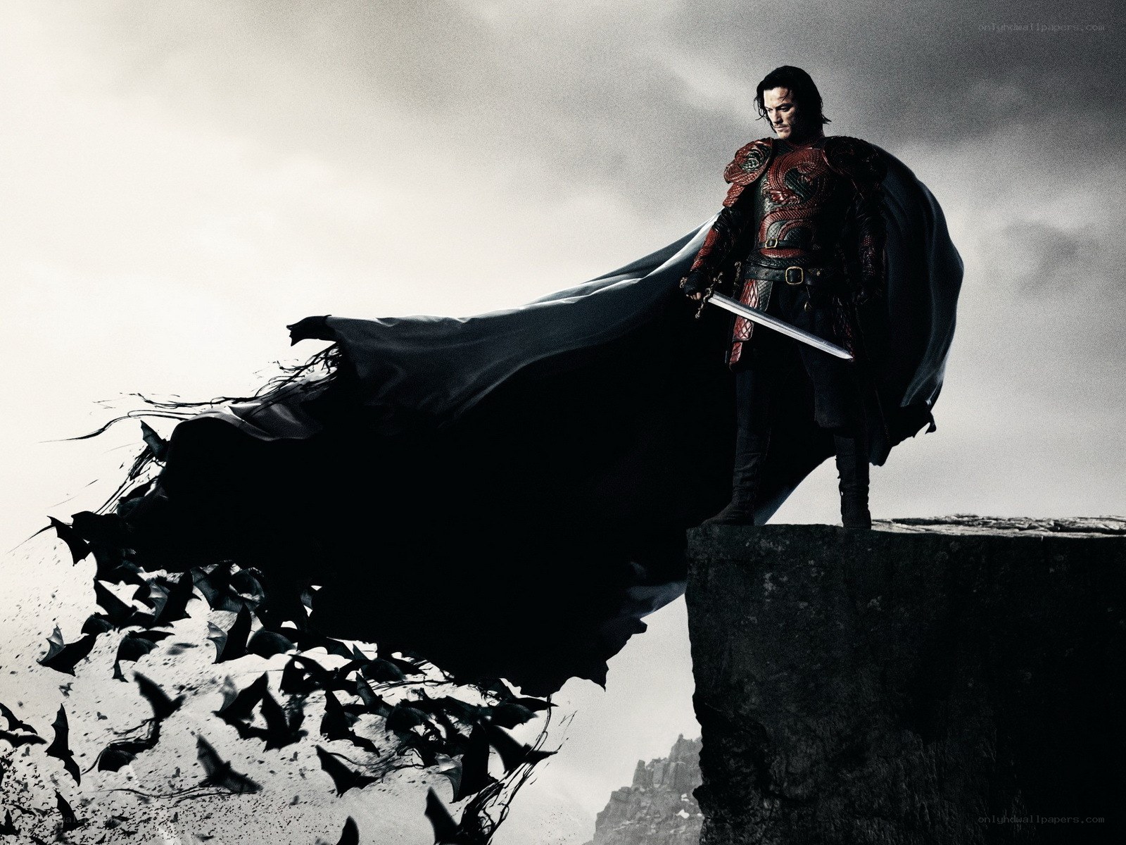 man with sword on cliff