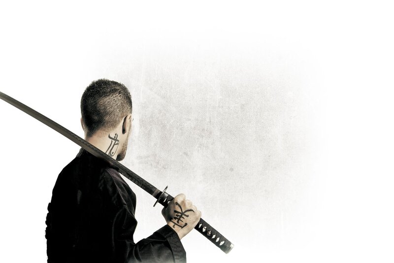 man with sword on shoulder