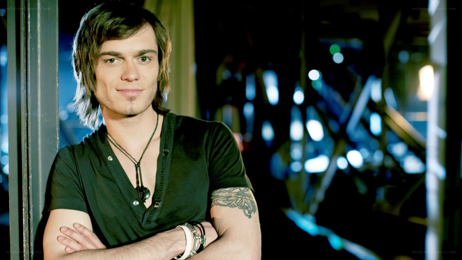 man with tattoo and necklace