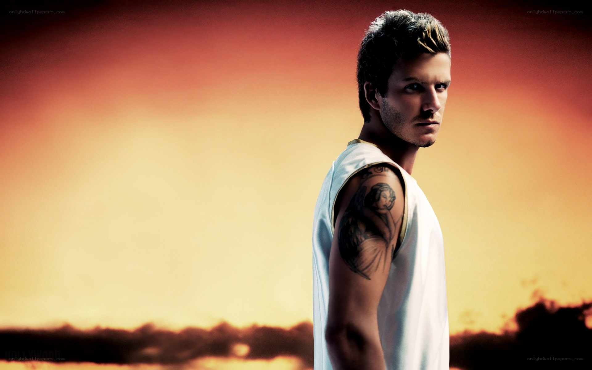 man with tattoo at sunset