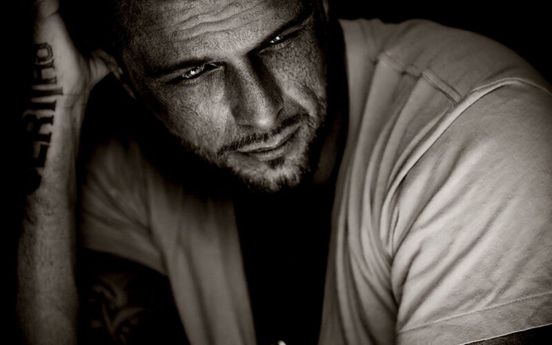 man with tattoo looking down