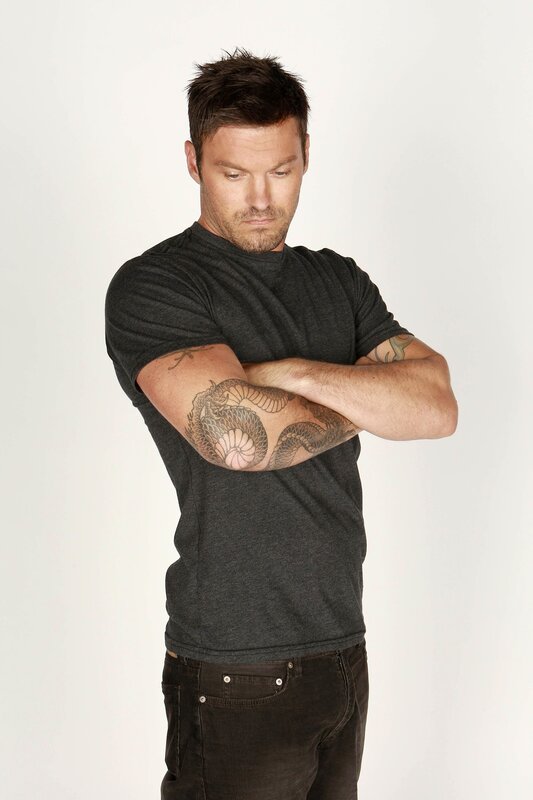 man with tattooed arms