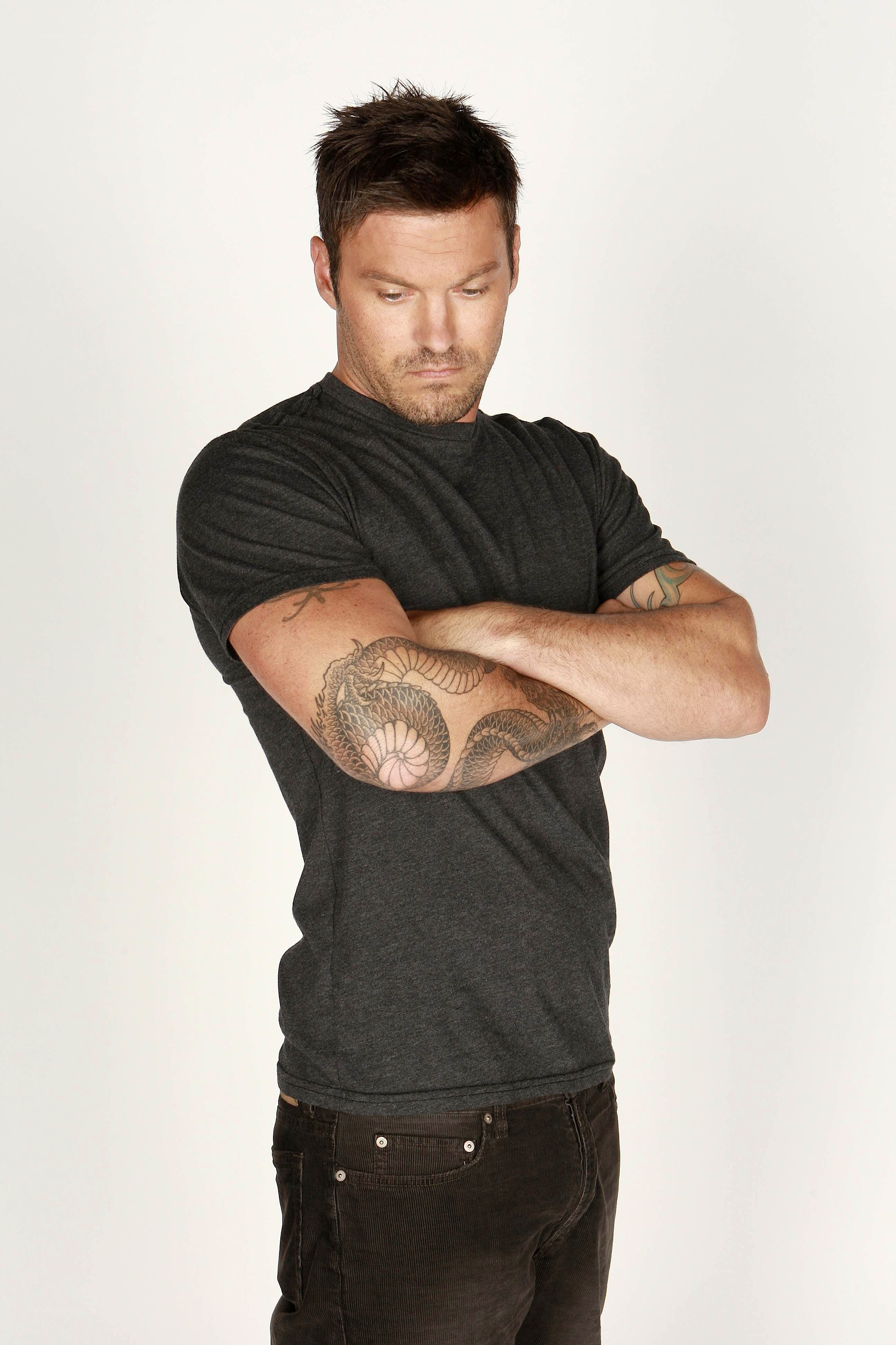 man with tattooed arms