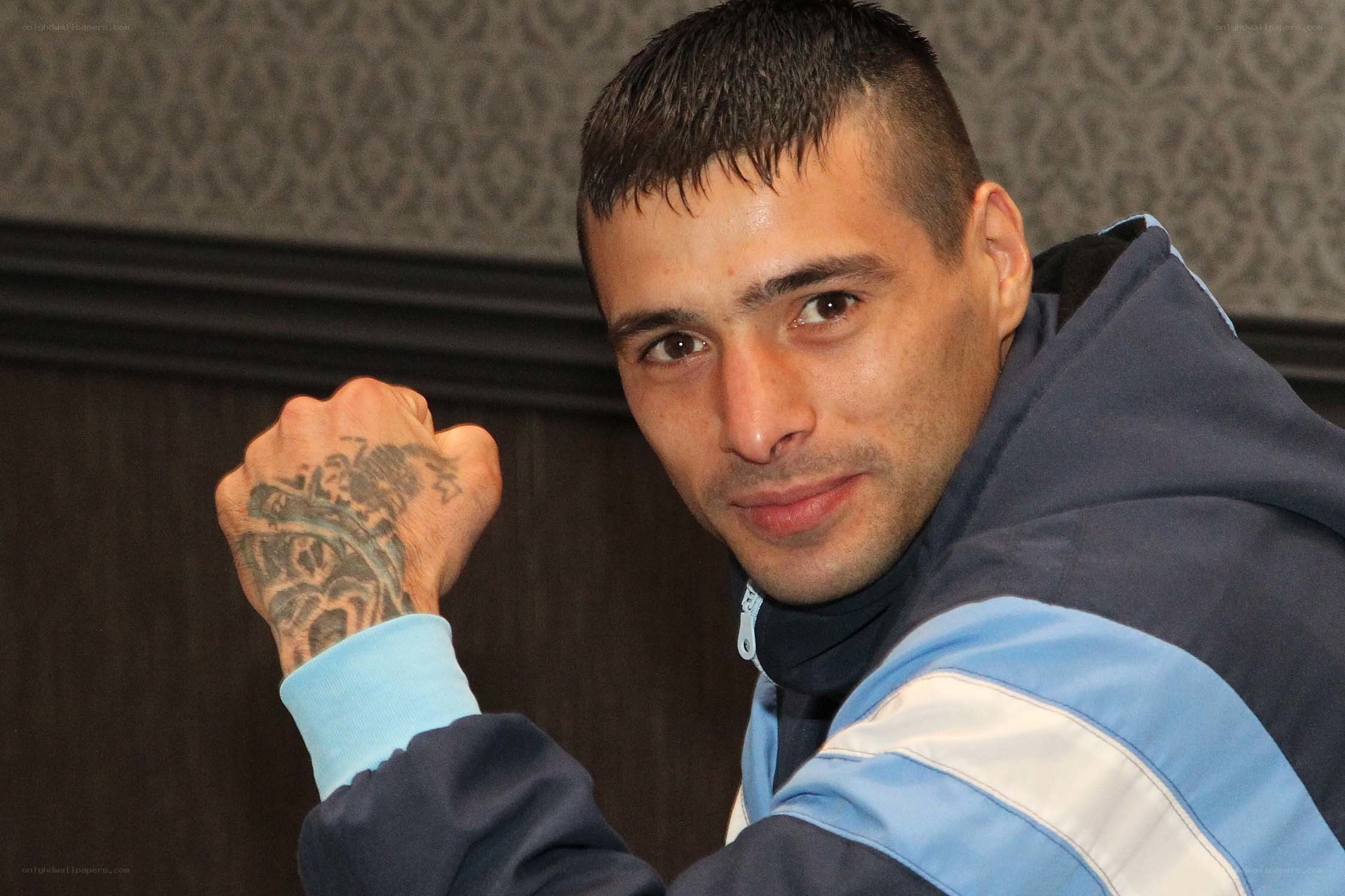 man with tattooed fist