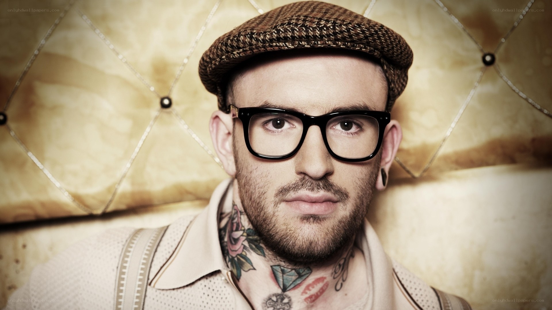 man with tattoos and glasses