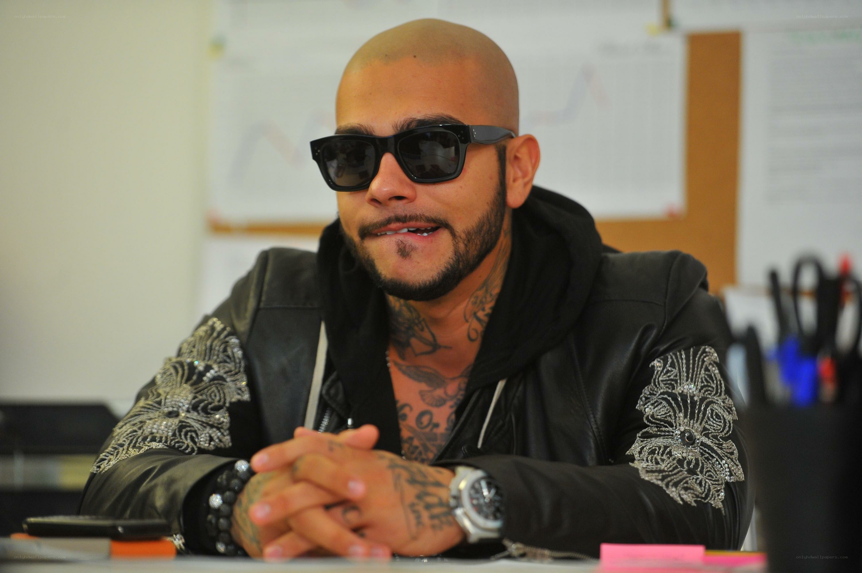 man with tattoos and sunglasses