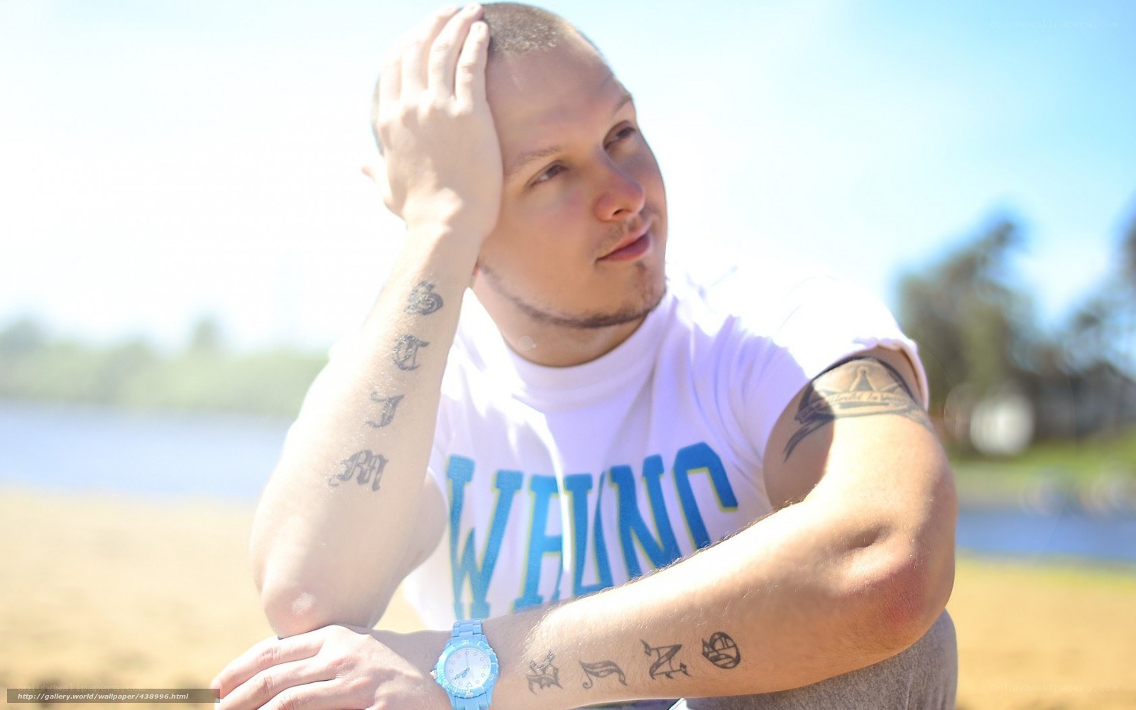 man with tattoos at beach