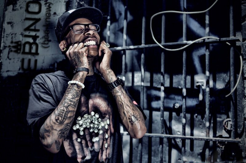 man with tattoos holding diamonds
