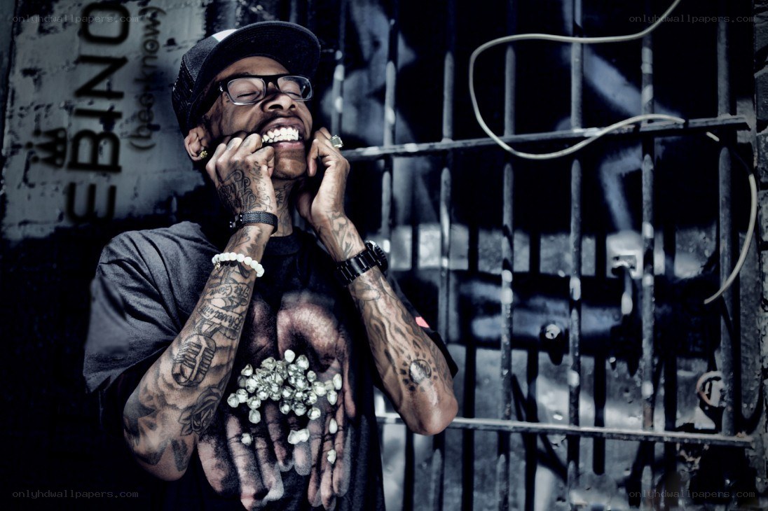 man with tattoos holding diamonds