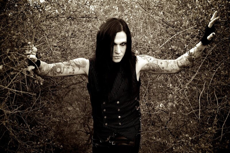Man with Tattoos in Bushes