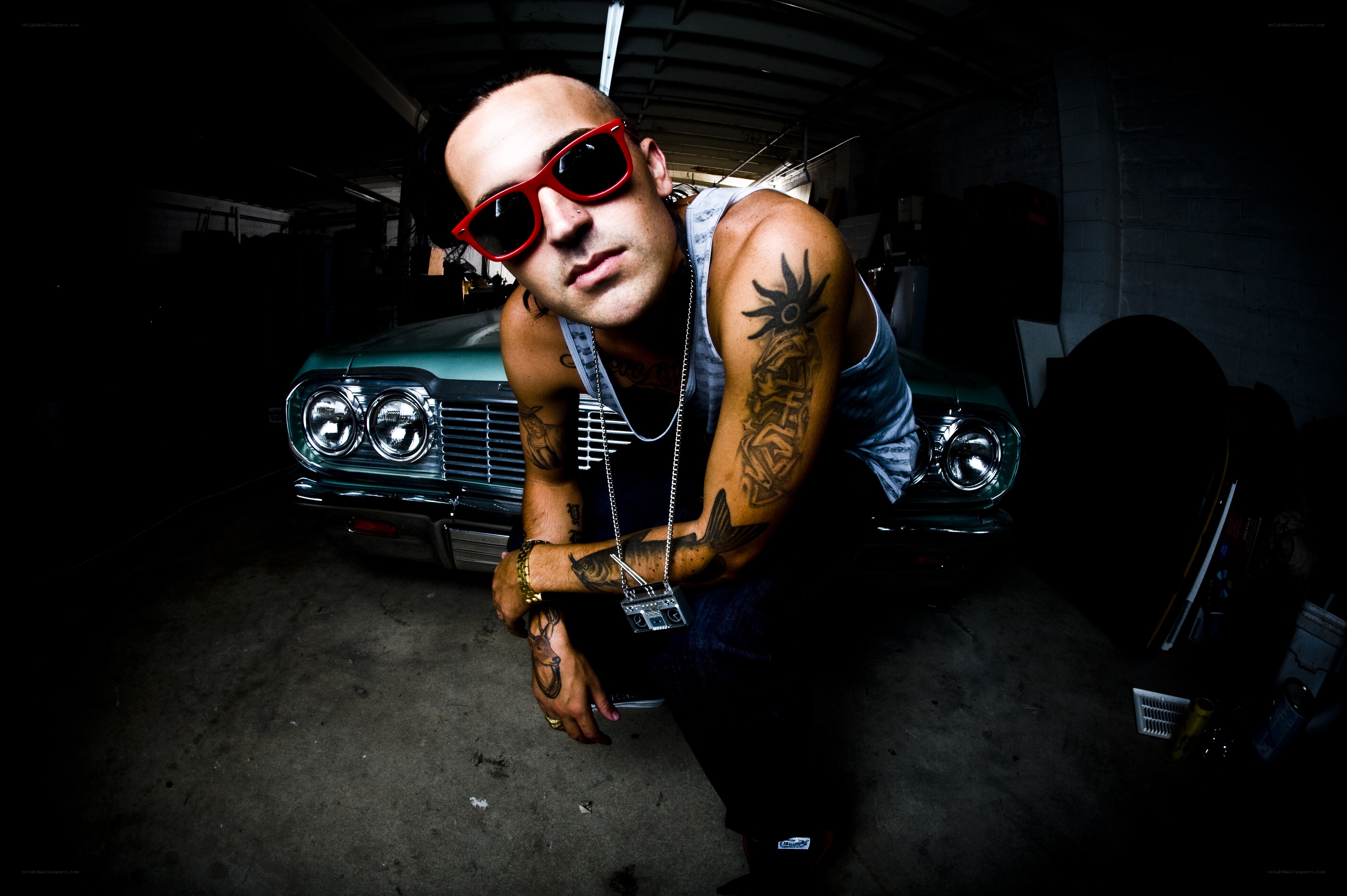 man with tattoos in garage