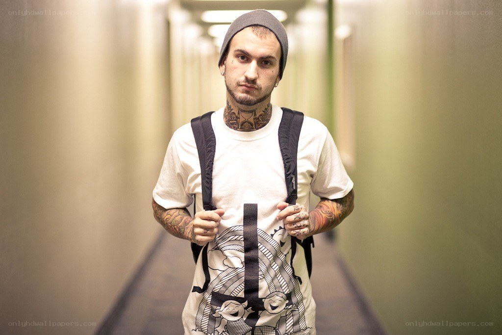 man with tattoos in hallway
