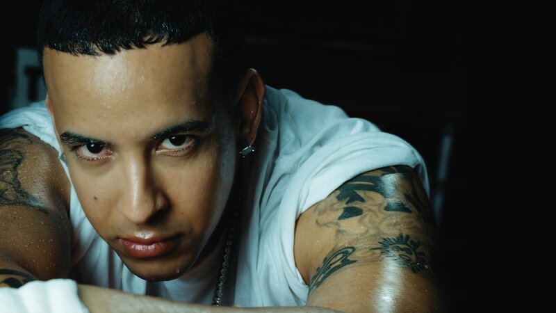man with tattoos looking at camera