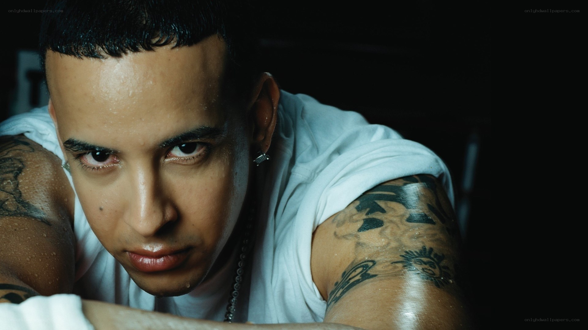 man with tattoos looking at camera