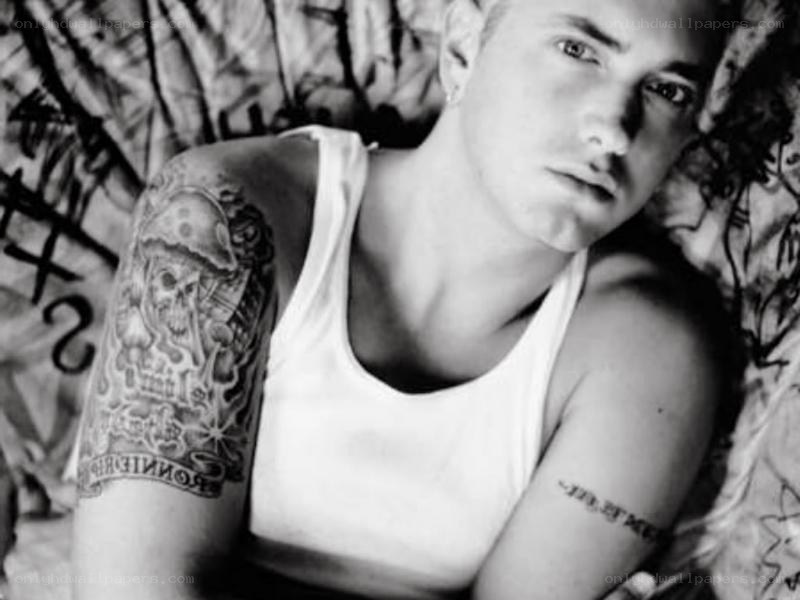 man with tattoos on bed