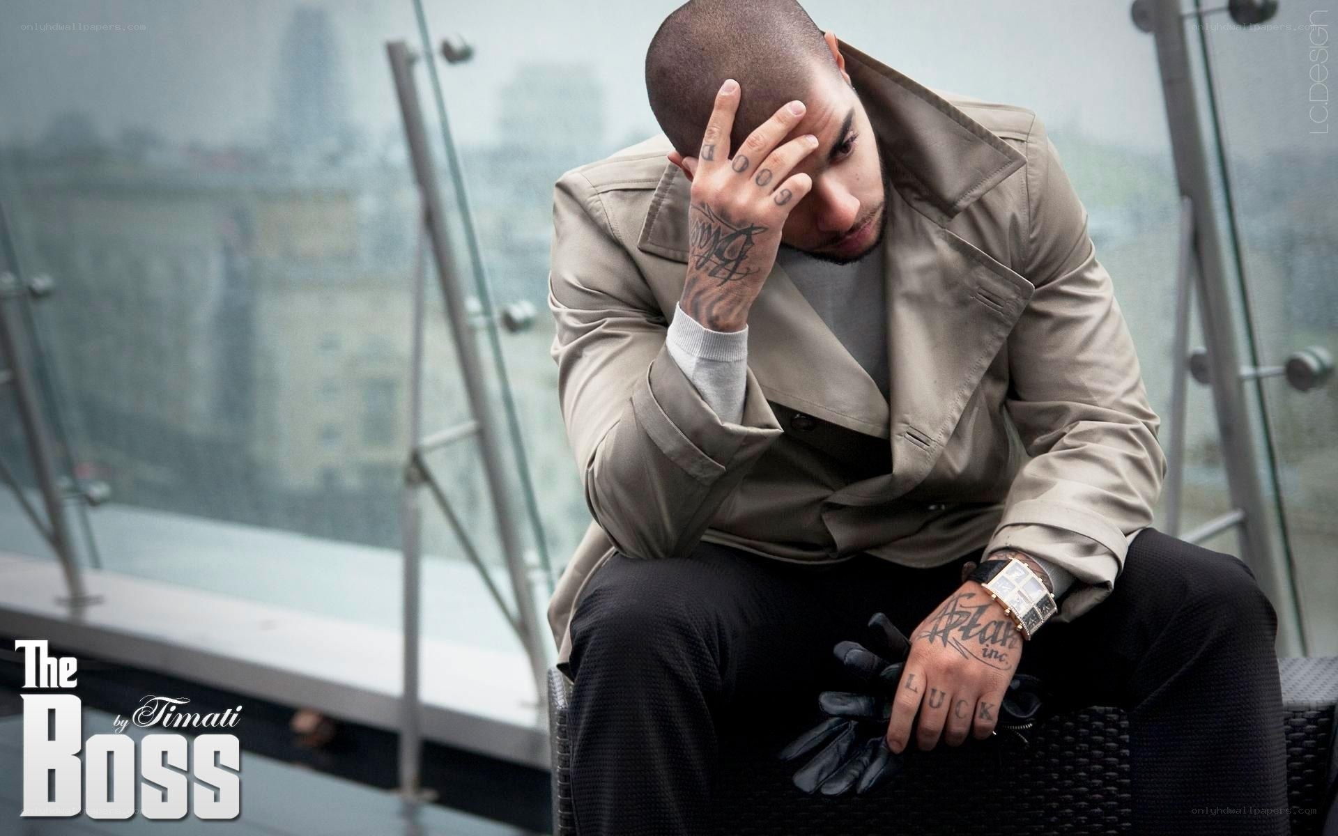 man with tattoos on rooftop