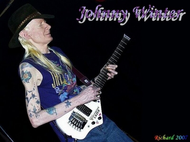 Man with Tattoos Playing Guitar