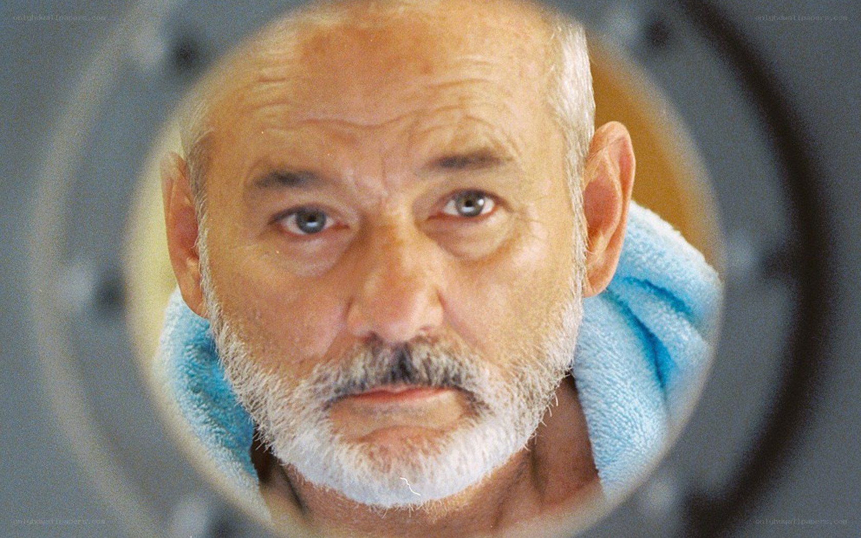 man with towel through porthole