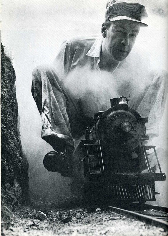 Man with toy train in tunnel