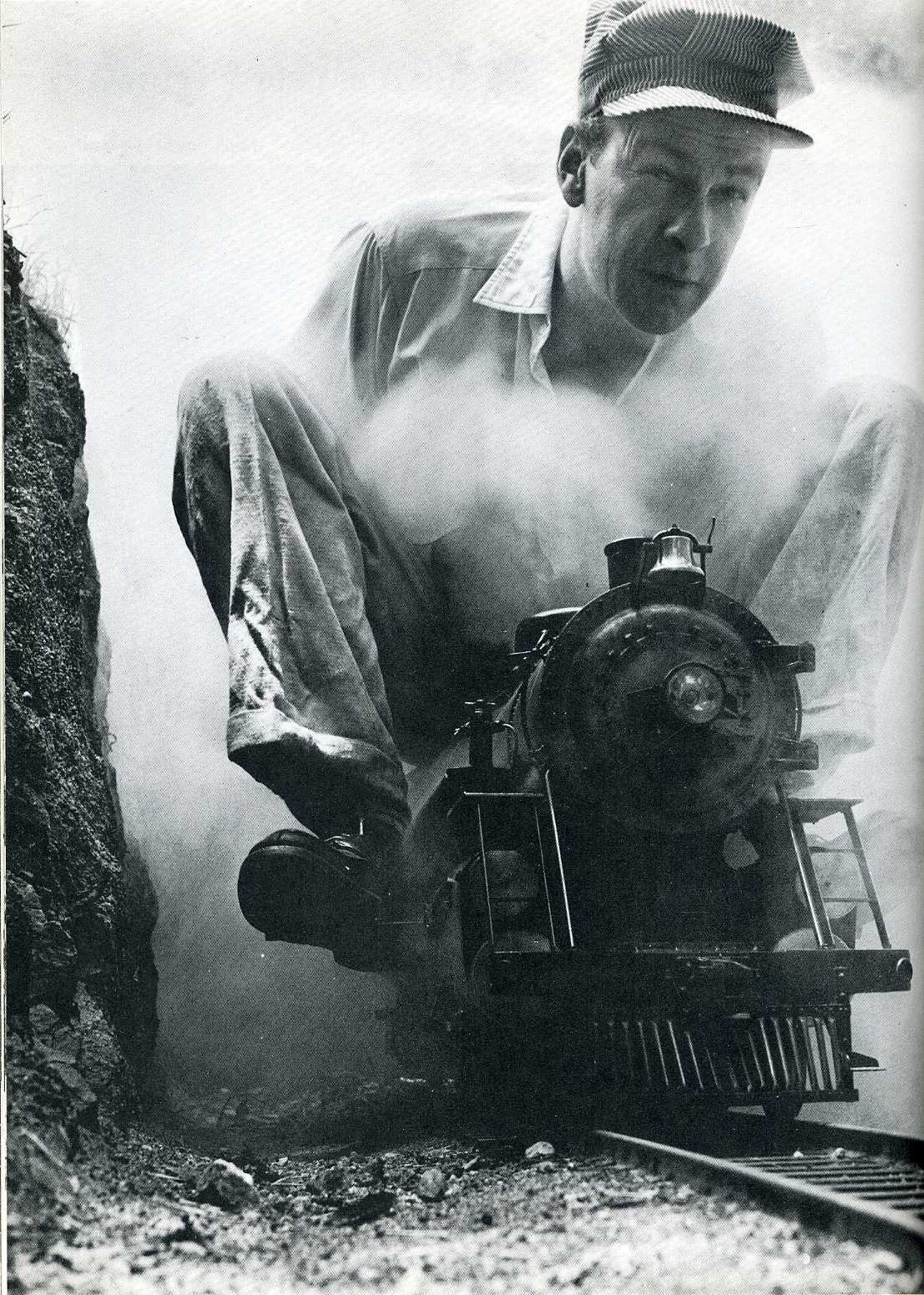 Man with toy train in tunnel