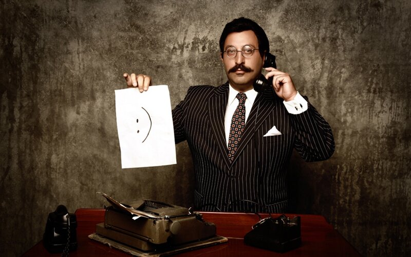 Man with typewriter and smiley face