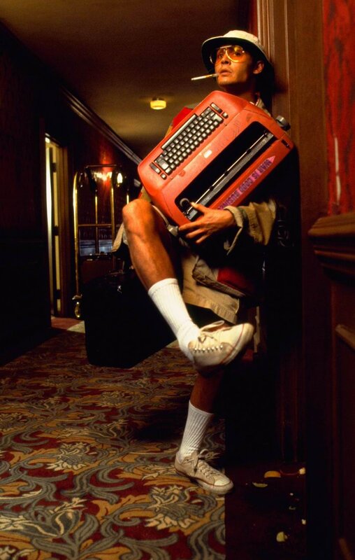 Man with typewriter in hallway