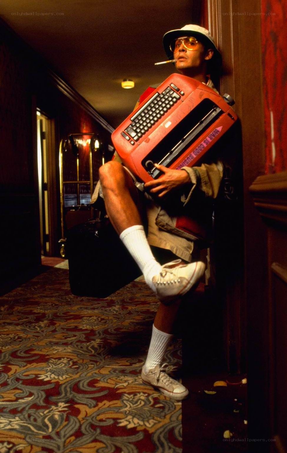 Man with typewriter in hallway
