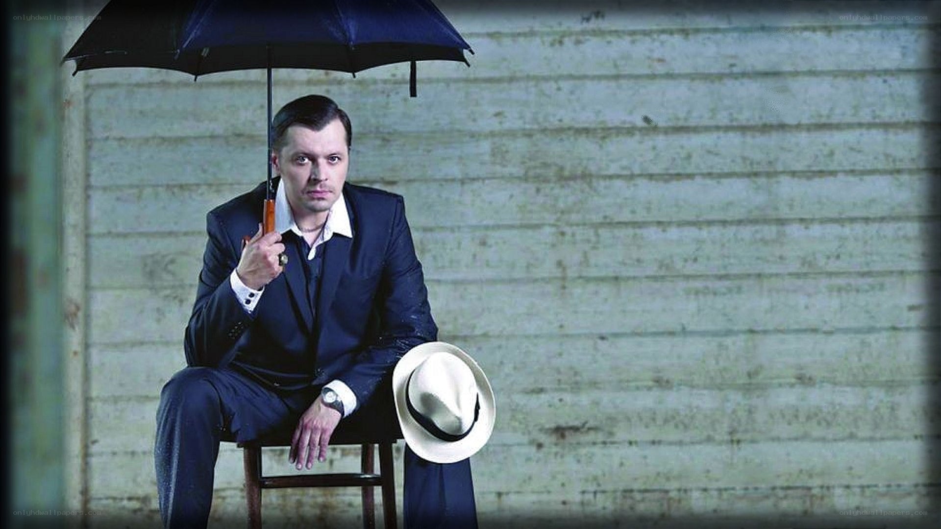 man with umbrella and hat