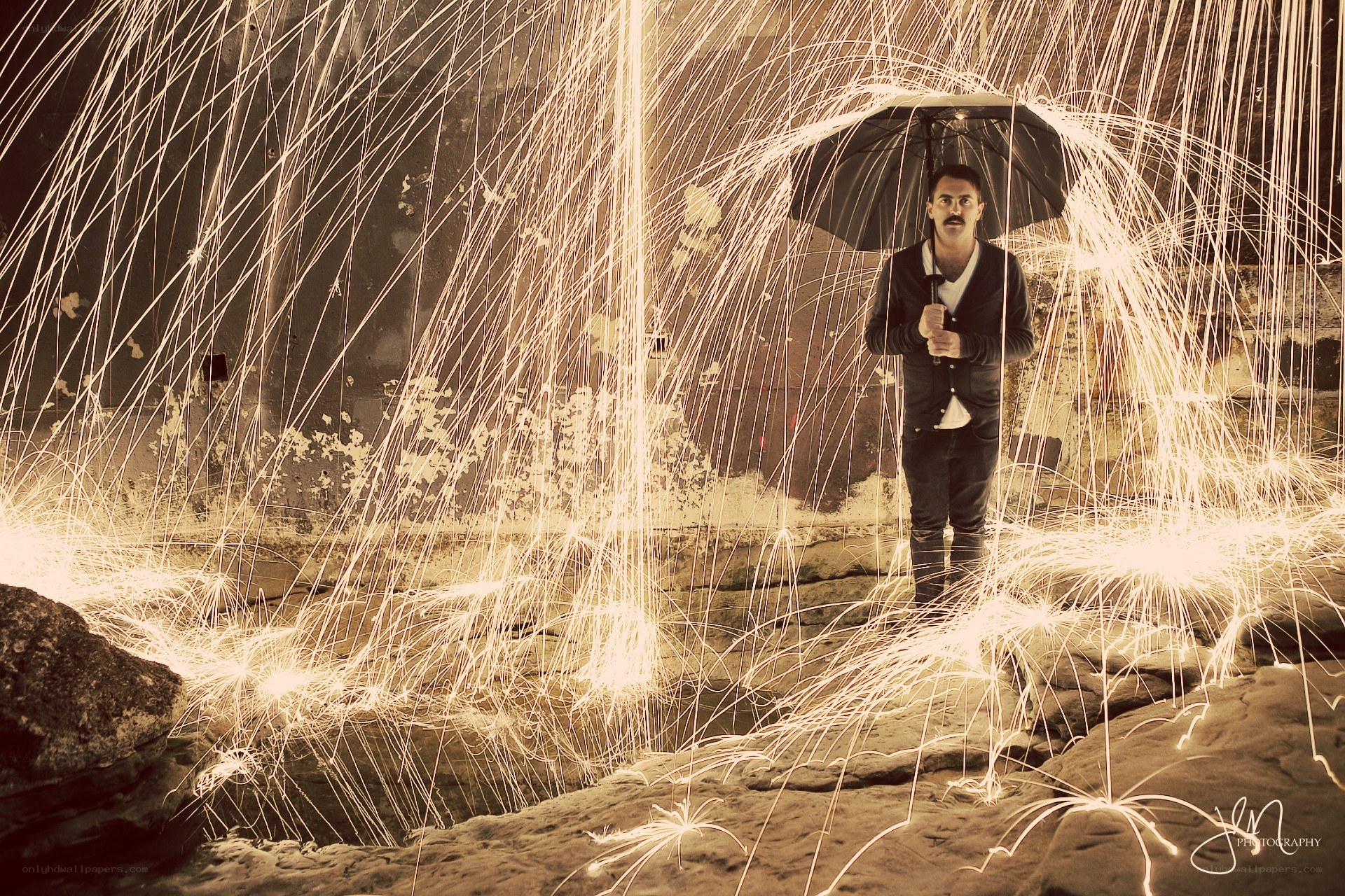 Man with umbrella in sparks
