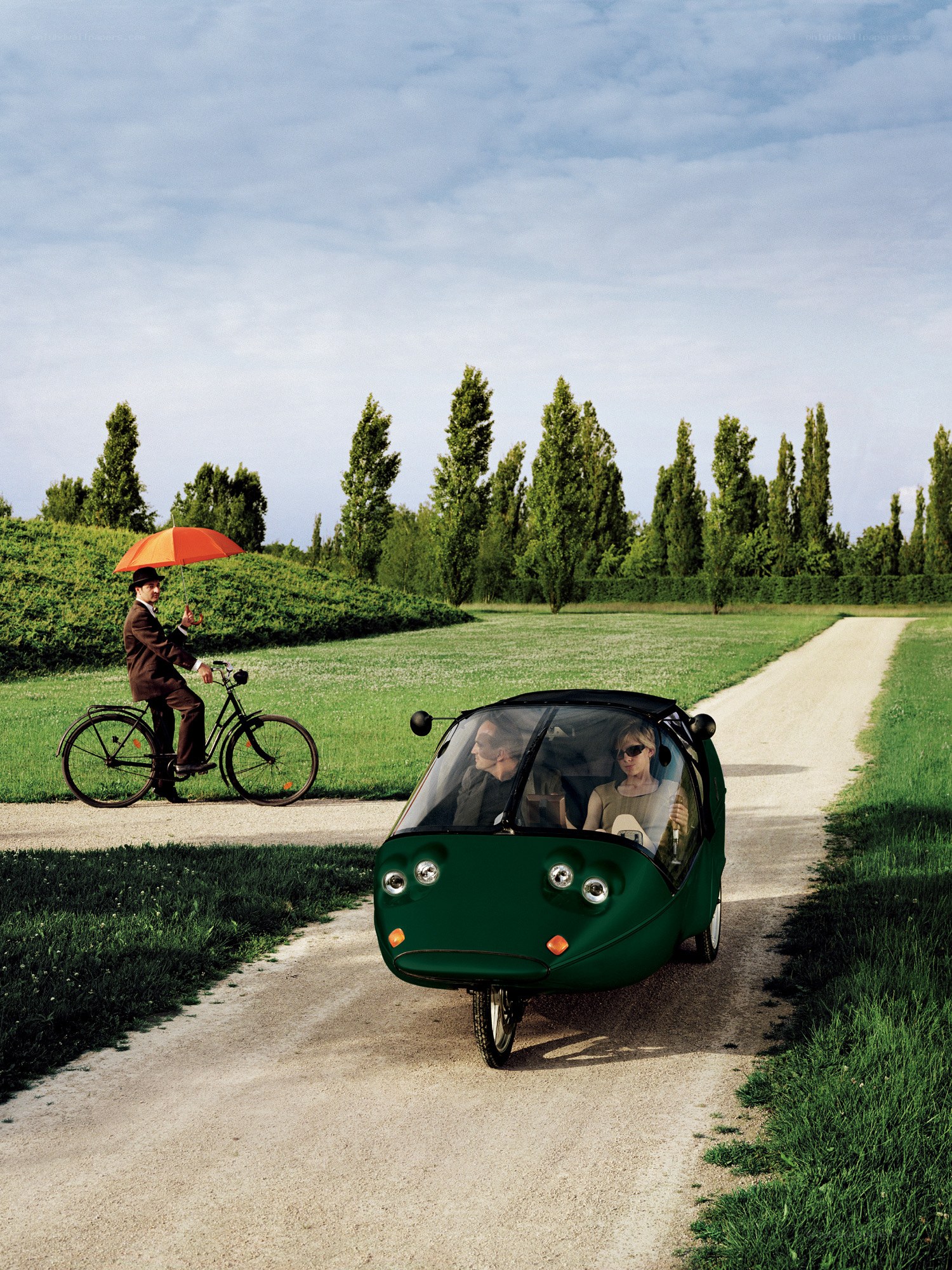 Man with umbrella on bicycle