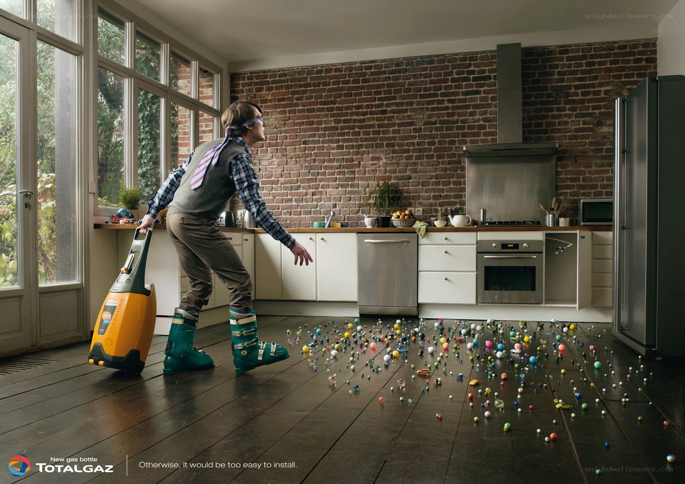 Man with vacuum cleaner in kitchen