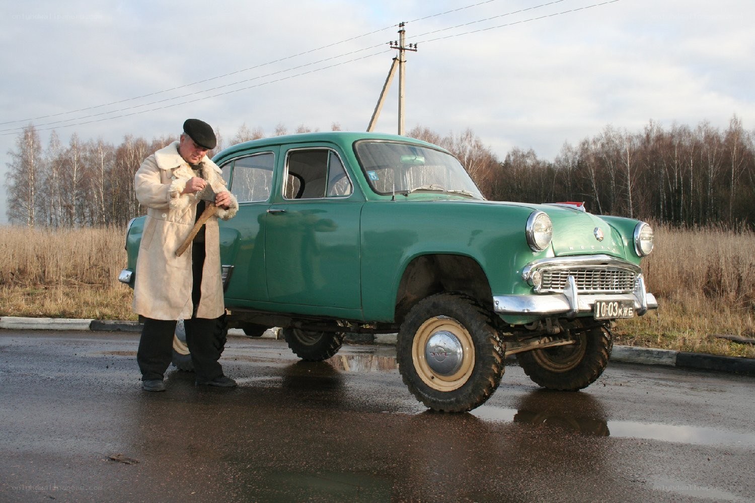 Man with vintage car