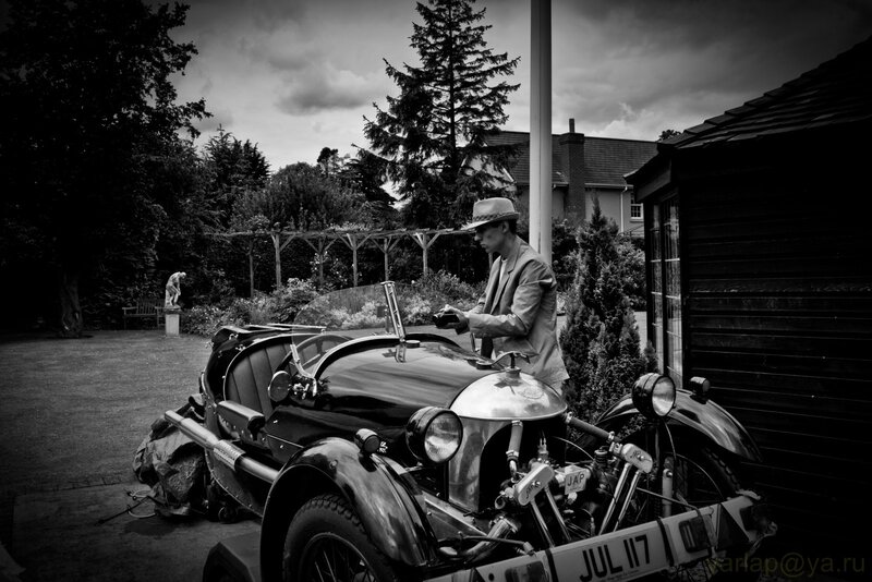 Man with vintage car in garden
