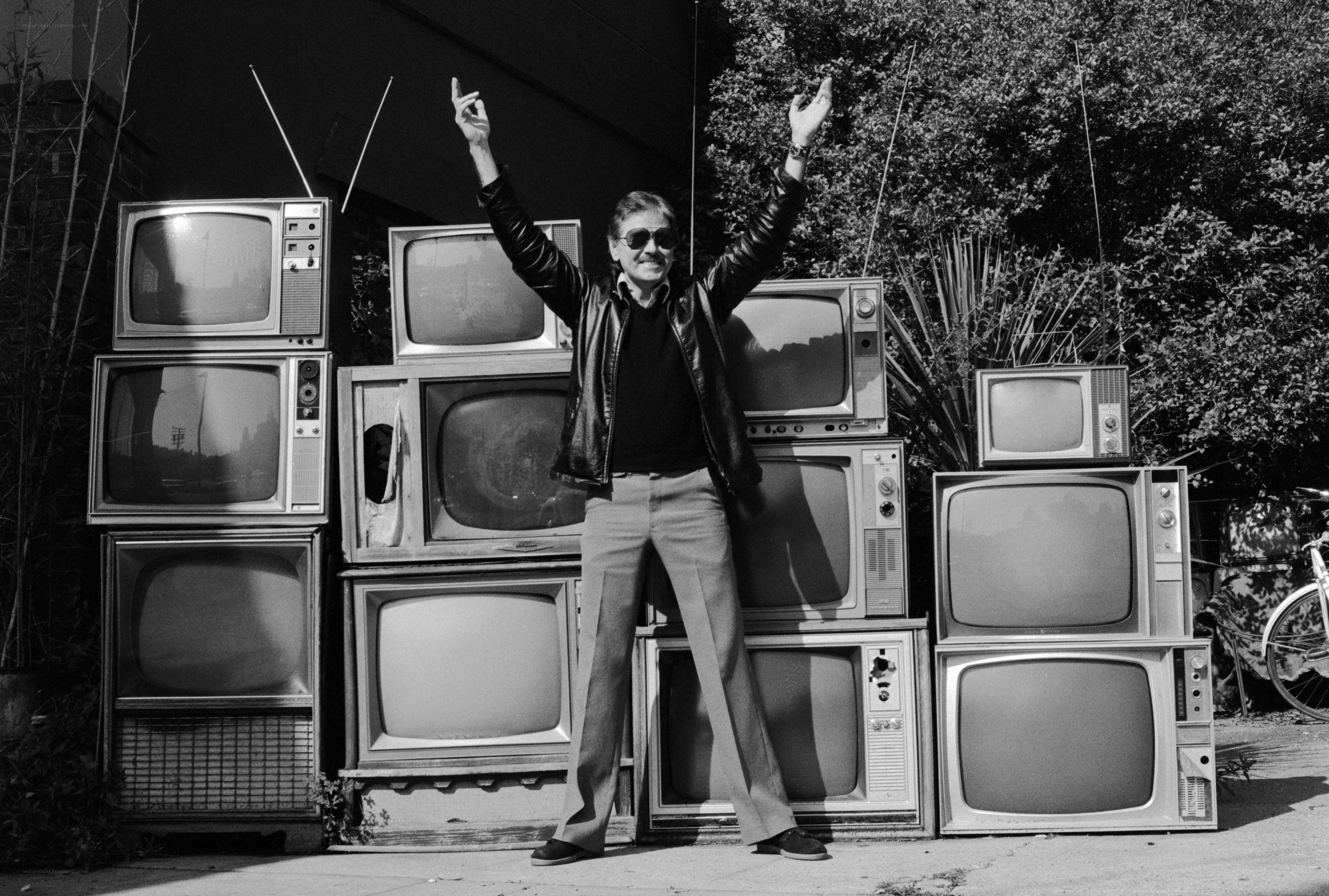 Man with vintage TVs