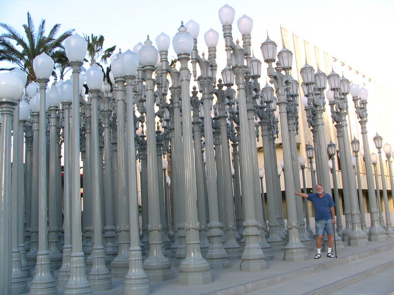 Man with walking stick among lamp posts