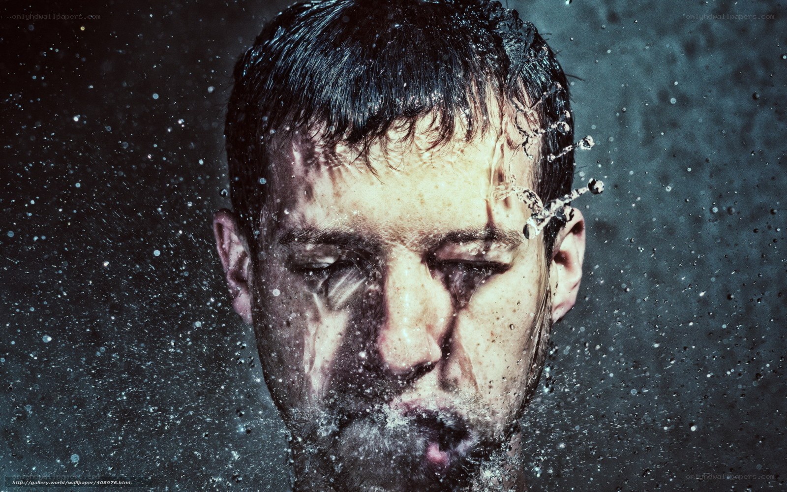 man with water splashing on face